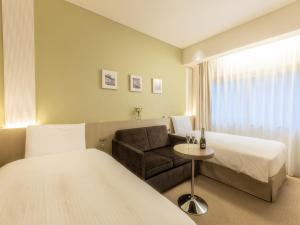 Postel nebo postele na pokoji v ubytování Hotel Gracery Ginza