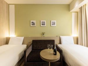 Postel nebo postele na pokoji v ubytování Hotel Gracery Ginza