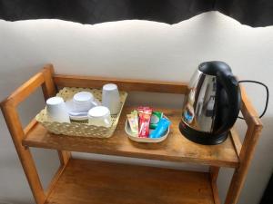 a tea kettle sitting on a table under a bed at Sleep inn Samui in Choeng Mon Beach
