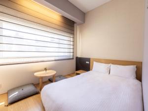 Postel nebo postele na pokoji v ubytování Hotel Gracery Ginza