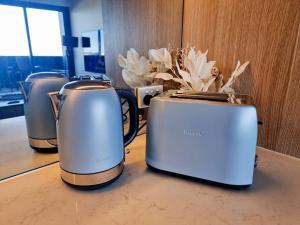 three toasters sitting on top of a counter at 2 Bedrooms Aptmt with Ocean View in Geelong