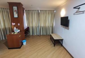 a hotel room with a desk and a television at Hotel Ching Hua in Segamat