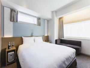 Postel nebo postele na pokoji v ubytování Hotel Gracery Ginza