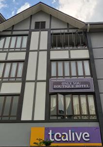 a building with a sign for a hotel at Only You Boutique Hotel Centrum Cameron Highlands in Brinchang