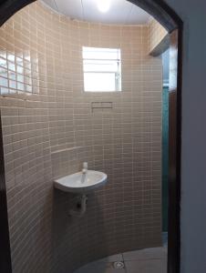 a bathroom with a sink and a window at Espaço do Bem Recife in Recife