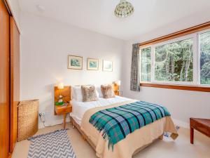 a bedroom with a bed and a window at Cathel Sheiling in Thurso