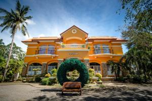 a yellow house with a wreath in front of it at San Remigio Beach Club in San Remigio