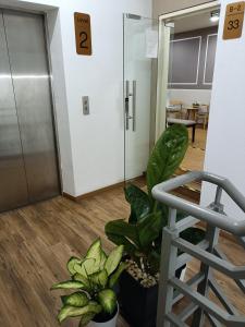 an office hallway with plants and an elevator at Only You Boutique Hotel Centrum Cameron Highlands in Brinchang