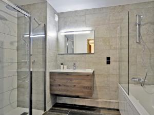 a bathroom with a sink and a shower and a mirror at Appartement Huez, 2 pièces, 2 personnes - FR-1-645-60 in LʼHuez