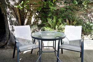 two chairs and a table and a table and two chairs at A Quaint Darlinghurst Cottage in Sydney