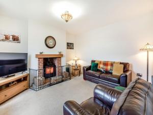 a living room with a couch and a fireplace at Binchester Crag Farm in Bishop Auckland