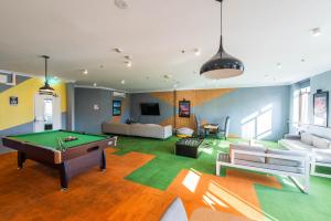 a living room with a pool table in it at Space Q Capsule Hotel in Sydney +9 photos