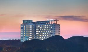 a building with a hotel sign on top of it at Novotel Makassar Grand Shayla in Makassar