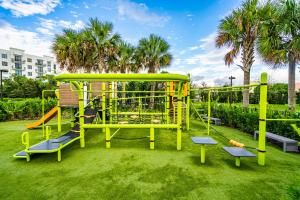 a playground in a park with a slide at Modern 2 Bed in the Heart of Doral Free Parking in Hialeah Gardens