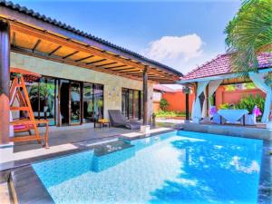 a swimming pool in the backyard of a house at One Bedroom Private Villa Kuta in Seminyak