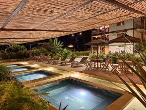 a swimming pool with a patio with tables and chairs at Finca del Café - Casa Bourbon in Santa Rosa de Cabal