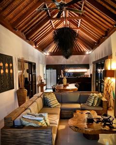 a living room with a couch and a ceiling at Amalika Private Pool Villa Central to Everything in Gili Trawangan