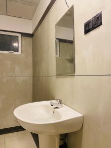 a white sink in a bathroom with a mirror at Sea lane Villa in Weligama