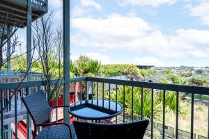 a balcony with two chairs and a table at Light Resort Style Haven in Darling Harbour in Sydney