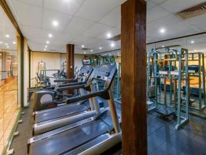 a gym with rows of treadmills and machines at Light Resort Style Haven in Darling Harbour in Sydney