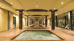 a pool of water in a large room with columns at Light Resort Style Haven in Darling Harbour in Sydney