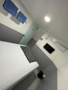 een slaapkamer met een wit bed en blauwe borden aan de muur bij Quarto privativo com banheiro compartilhado em Pousada recém construída,a 500mts do pátio do forró in Caruaru