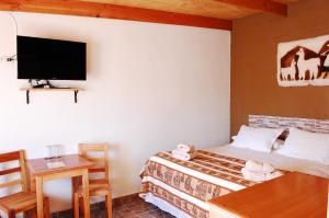 Ένα ή περισσότερα κρεβάτια σε δωμάτιο στο Hostal Pablito