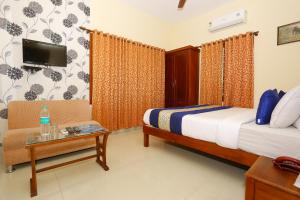 OYO Flagship 5202 Hotel Pearl Malabar tesisinde bir odada yatak veya yataklar