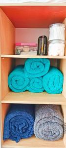 a wooden shelf with blue towels on it at Private studio unit with balcony near the beaches in Lapu Lapu City