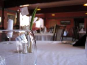 a table with a white table cloth with a vase of flowers at Queenstown Motor Lodge in Queenstown