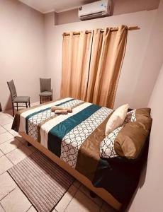 a bedroom with a bed and two chairs at Amplia, independiente y segura vivienda de 2 habitaciones in Machala