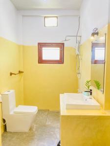 a bathroom with a white toilet and a sink at Villa bodhi Ahangama, Home stay in Ahangama +13 photos