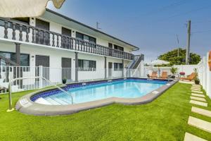 a swimming pool in a yard next to a building at 2BR Cozy FLL Retreat! in Fort Lauderdale