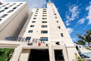 a tall white building with a hotel sign on it at Hound Hotel Mokpo Peace Plaza in Mokpo