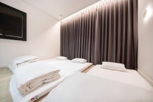 Krevet ili kreveti u jedinici u objektu Hound Hotel Mokpo Peace Plaza