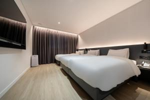 Krevet ili kreveti u jedinici u objektu Hound Hotel Mokpo Peace Plaza