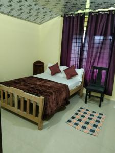 a bedroom with a bed with purple curtains and a chair at Samz estate stay 2BHK in Madikeri