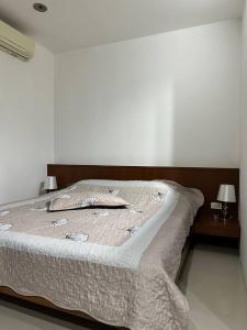 a large bed in a bedroom with two lamps at Apartment in Ban Mae Nam