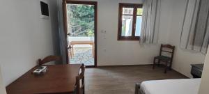 a dining room with a table and a room with a door at ODYSSEY BY CLIMBING HOUSE in Myrties