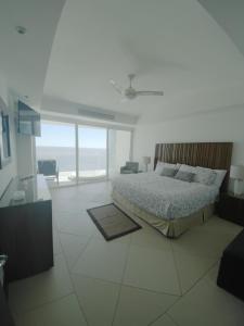 a bedroom with a bed and a view of the ocean at Bay View Grand Marina Ixtapa condo en pie de playa in Ixtapa