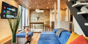 a living room with a blue couch and a table at Rakuten STAY VILLA Yamanakako in Yamanakako