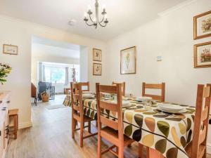 a dining room with a table and chairs at 4 bed in Bowcombe IC017 in Bowcombe