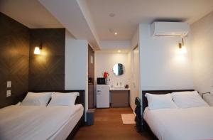 Postel nebo postele na pokoji v ubytování MARUKOU HOTEL