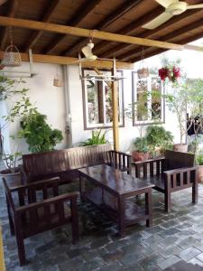 un patio con mesa, bancos y ventanas en The Chill River-Boutique Villa, en Siem Reap