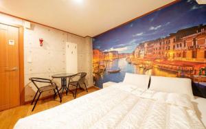 a bedroom with a large painting of a river at Chess Motel in Seoul