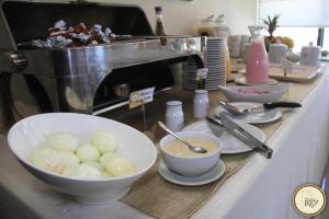 a kitchen counter with bowls of food and a mixer at Posada del Rey Hotel in Trujillo