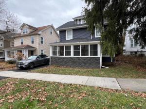 a car parked in front of a house at Spacious 5 Bed 2 Bath near Syracuse University and Downtown Syracuse With Lots of Amenities and Free Parking in Syracuse