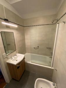 a bathroom with a sink and a shower and a toilet at Apartamento Malabia in Buenos Aires