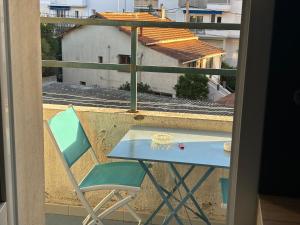 a blue table and a chair on a balcony at Brinette Room in Toulon