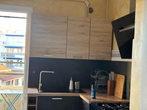 a kitchen with wooden cabinets and a sink at Brinette Room in Toulon